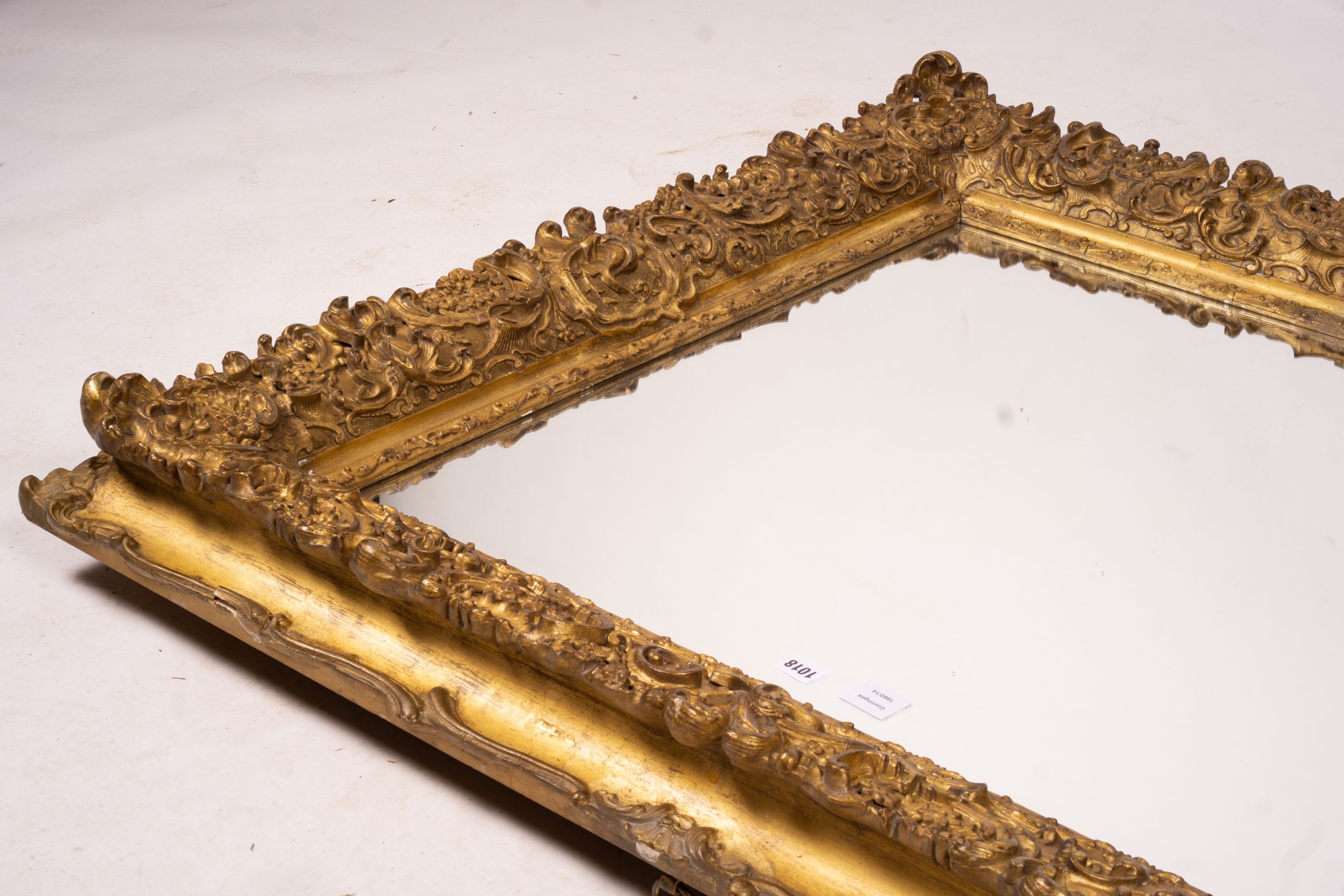 An ornate Victorian giltwood and gesso rectangular wall mirror (formerly a picture frame) width 130cm, height 112cm
